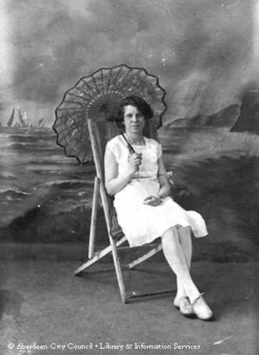 Studio portrait of a young lady sitting in a deckchair