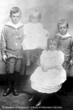 Studio portrait of 3 boys and a girl