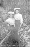 Portrait of two young ladies taken in a garden