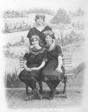 Studio portrait of three young ladies wearing swimming costumes