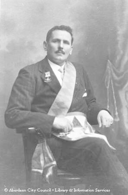 Portrait of a gentleman wearing a Masonic medal and sash