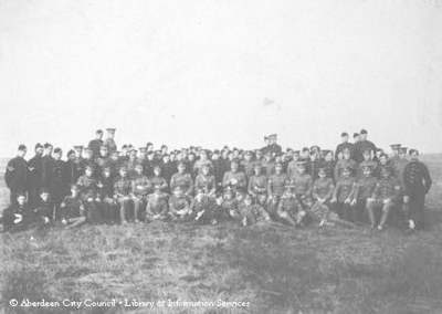 Outdoor group photograph of army officers and men, 1914