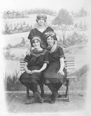 Studio portrait of three young ladies wearing swimming costumes