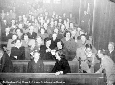Congregation seated in the pews of a church.